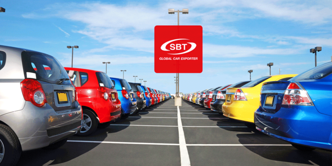 variety of colorful cars are parked on the road, bearing logo of SBT Japan.